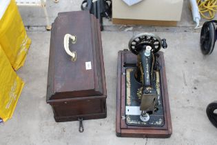 A VINTAGE SINGER SEWING MACHINE WITH WOODEN CARRY CASE