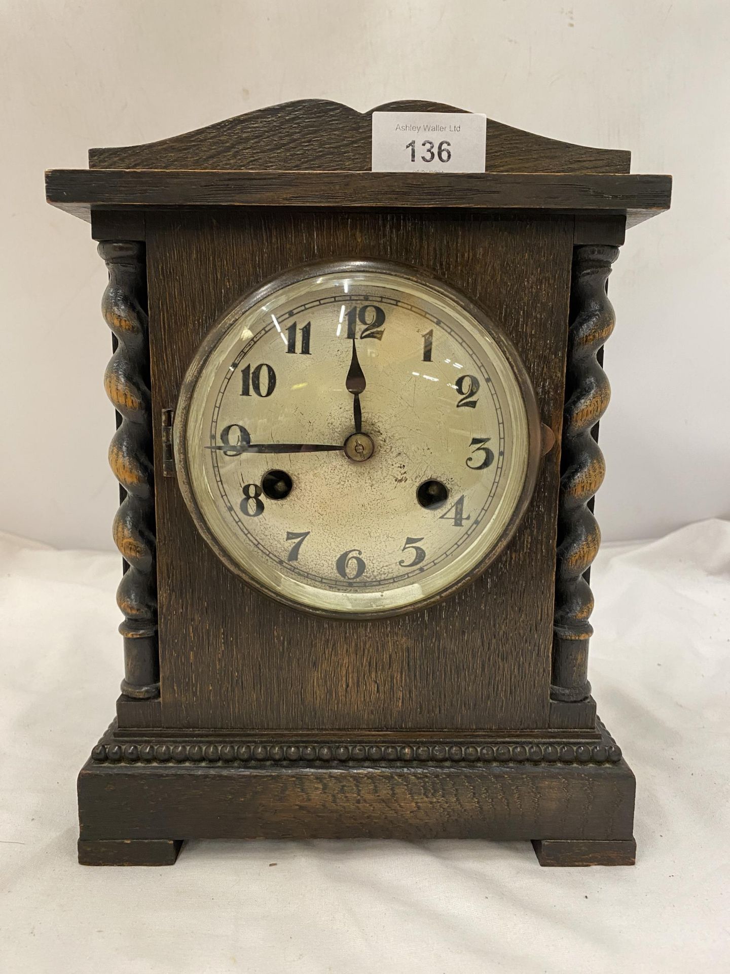 A WOODEN MANTLE CLOCK WITH BARLEY TWIST DESIGN