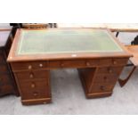 AN EDWARDIAN OAK TWIN-PEDESTAL DESK ENCLOSING NINE DRAWERS WITH INSET LEATHER TOP, 48" X 25"