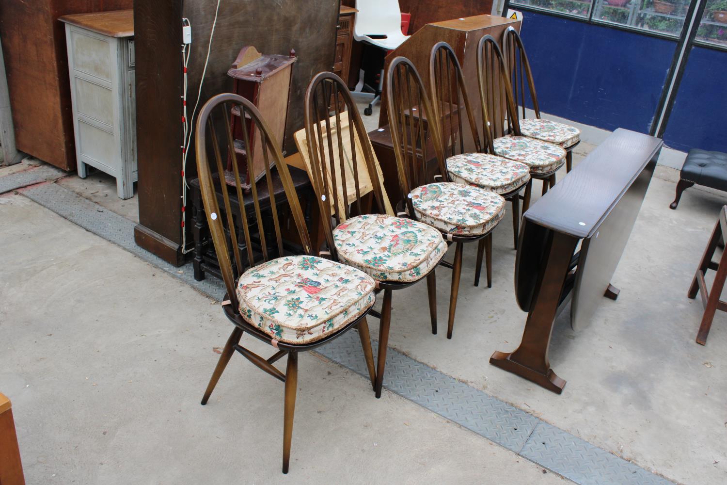 A SET OF SIX ERCOL WINDSOR STYLE DINING CHAIRS AND OVAL GATE-LEG DINING TABLE - 54" X 50" OPENED