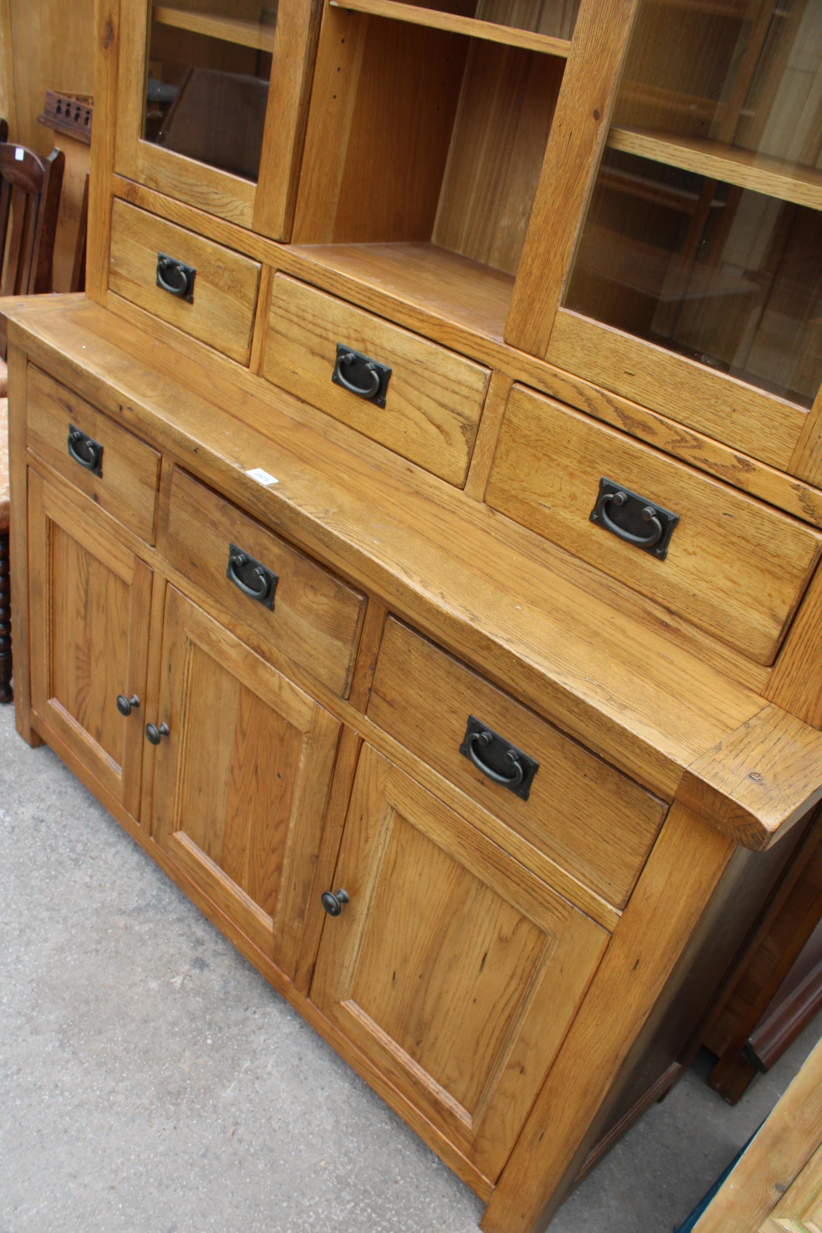 A OAK TWO DOOR BOOKCASE ON BASE, ENCLOSING SIX DRAWERS AND THREE CUPBOARDS, 55" WIDE - Image 6 of 6