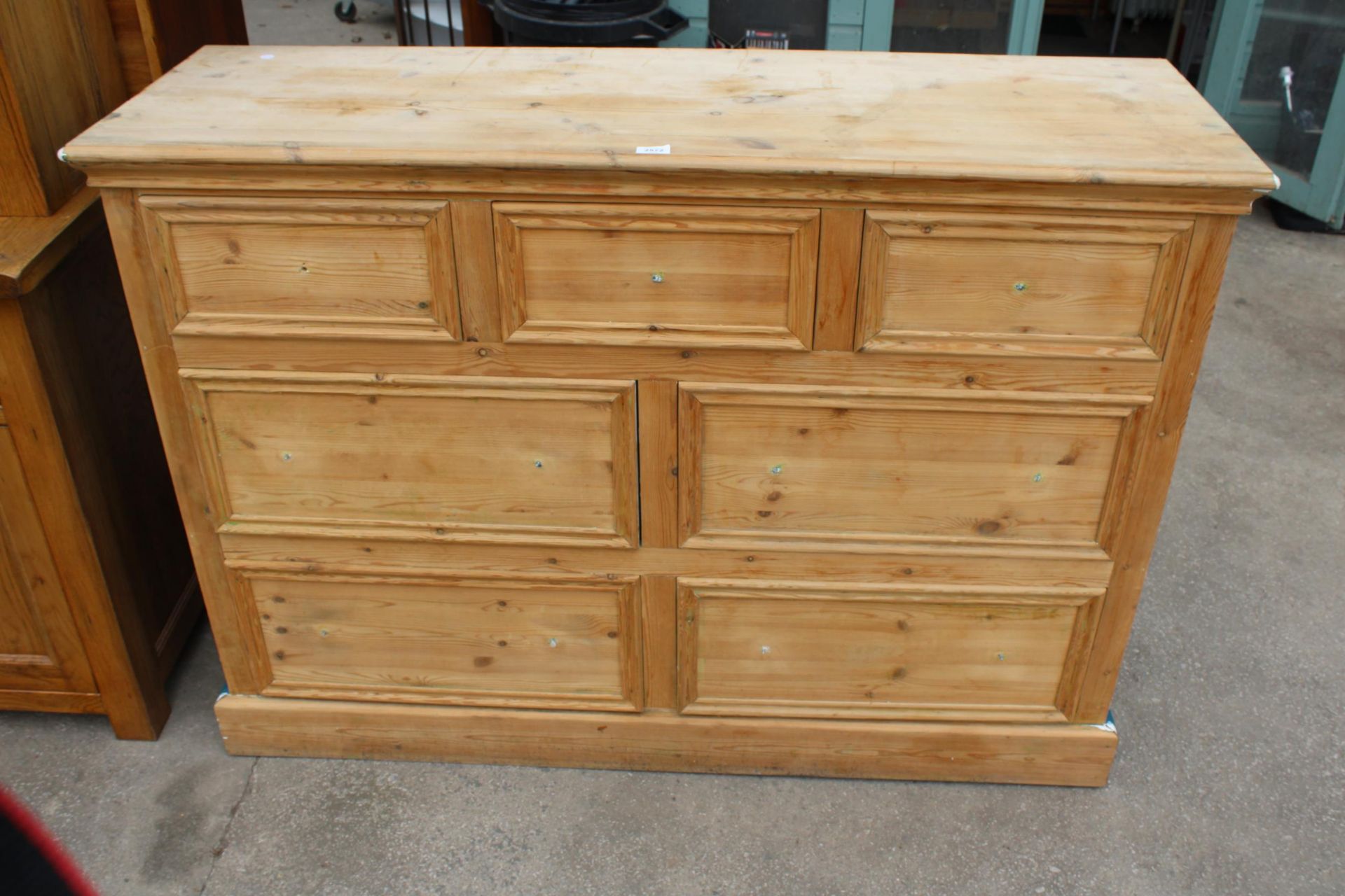 A PINE CHEST OF THREE SHORT AND FOUR LONG DRAWERS, 56" WIDE