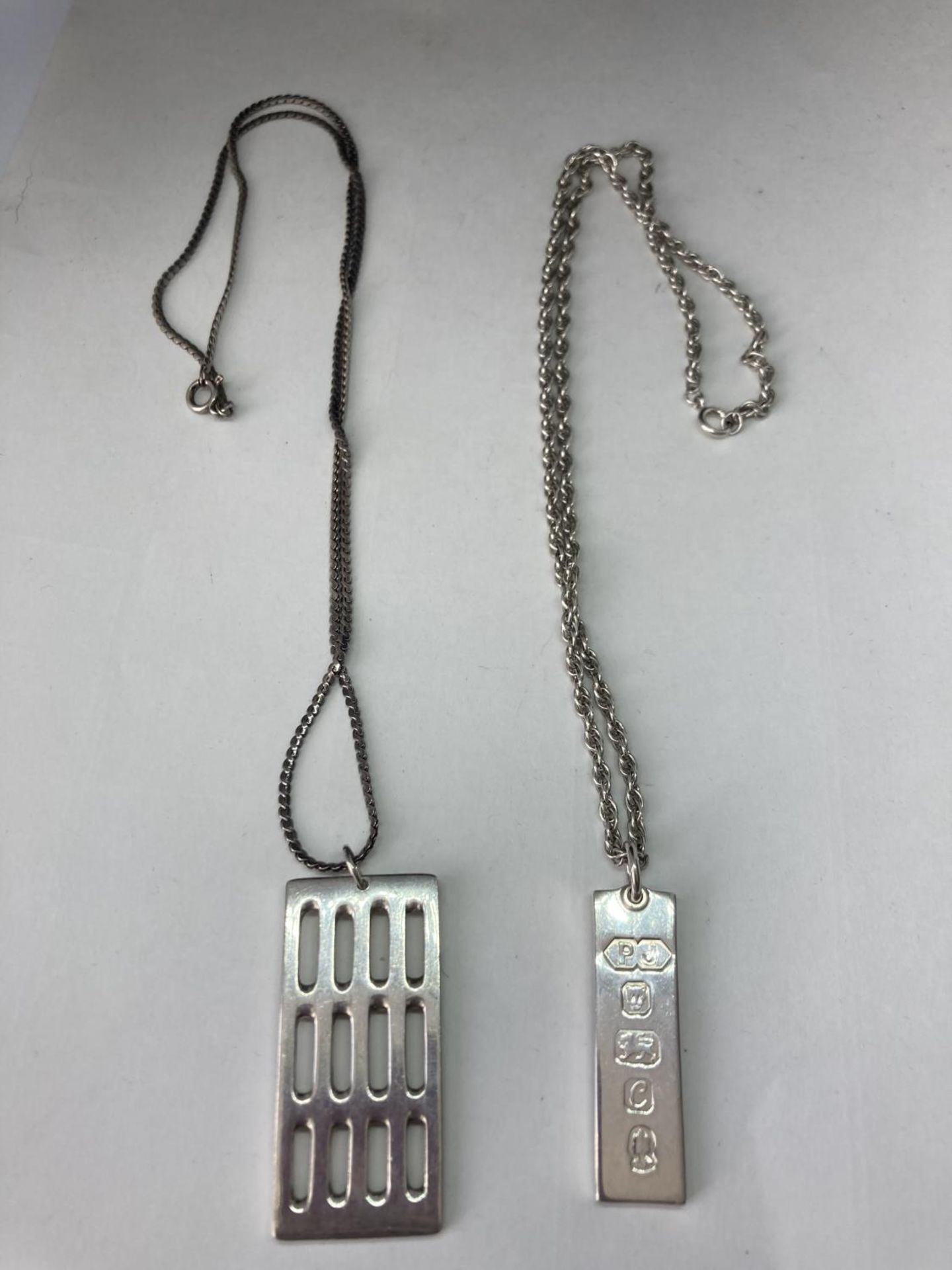 TWO SILVER NECKLACES WITH SILVER INGOT PENDANTS