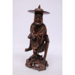 A VINTAGE ORIENTAL ROOTWOOD CARVING OF A HOLYMAN WEARING A TYPICAL COOLIE HAT WITH TEETH (