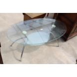 A MODERN OVAL TWO TIER GLASS COFFEE TABLE ON POLISHED CHROME LEGS