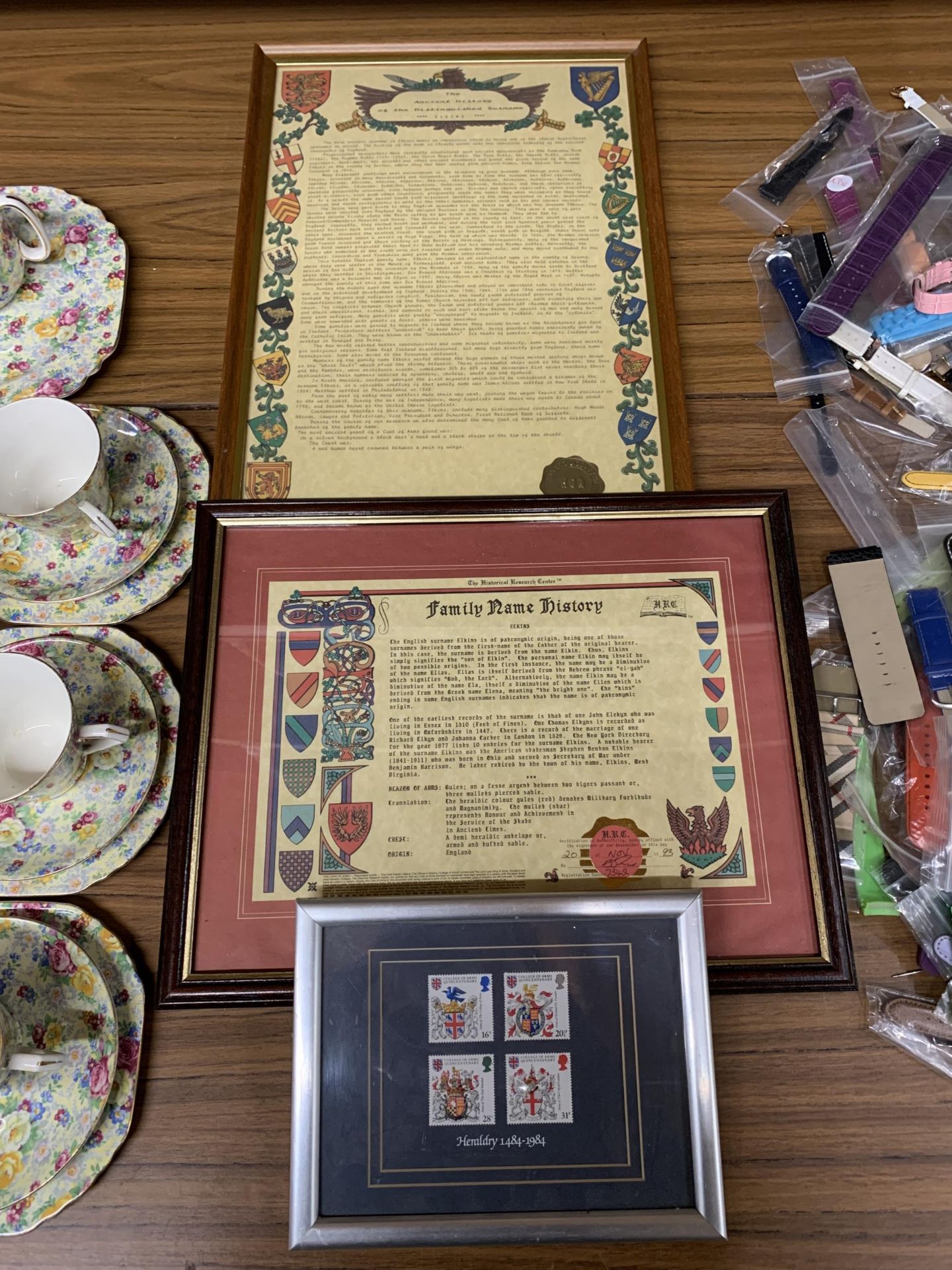 TWO FRAMED FAMILY HISTORY DOCUMENTS FOR THE NAME 'ELKINS' PLUS A SET OF FOUR HERALDRY STAMPS