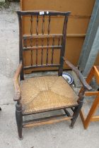 AN 18TH CENTURY ELM SPINDLE BACK ELBOW CHAIR