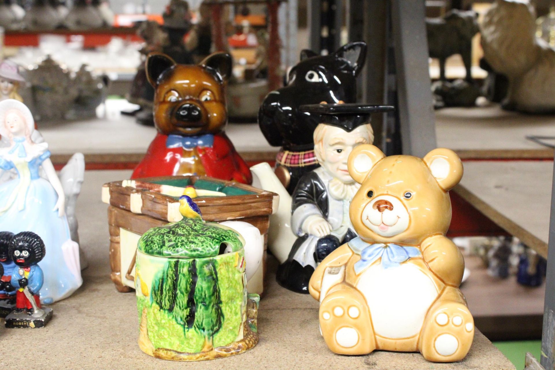 A QUANTITY OF NOVELTY CERAMICS TO INCLUDE TEAPOTS, MONEY BOX, COOKIE JAR AND PRESERVE POT