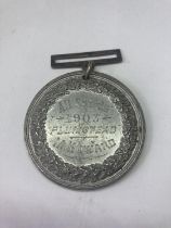 A SERVICE MEDAL DATED 1903