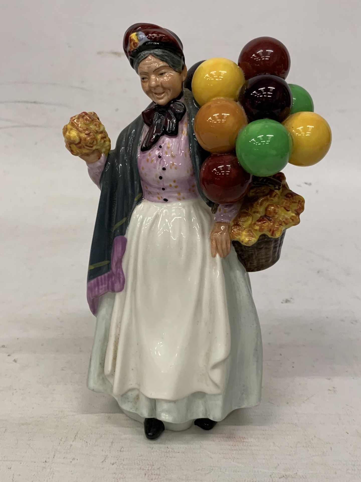 A ROYAL DOULTON FIGURINE "BIDDY PENNY FARTHING" HN 1843