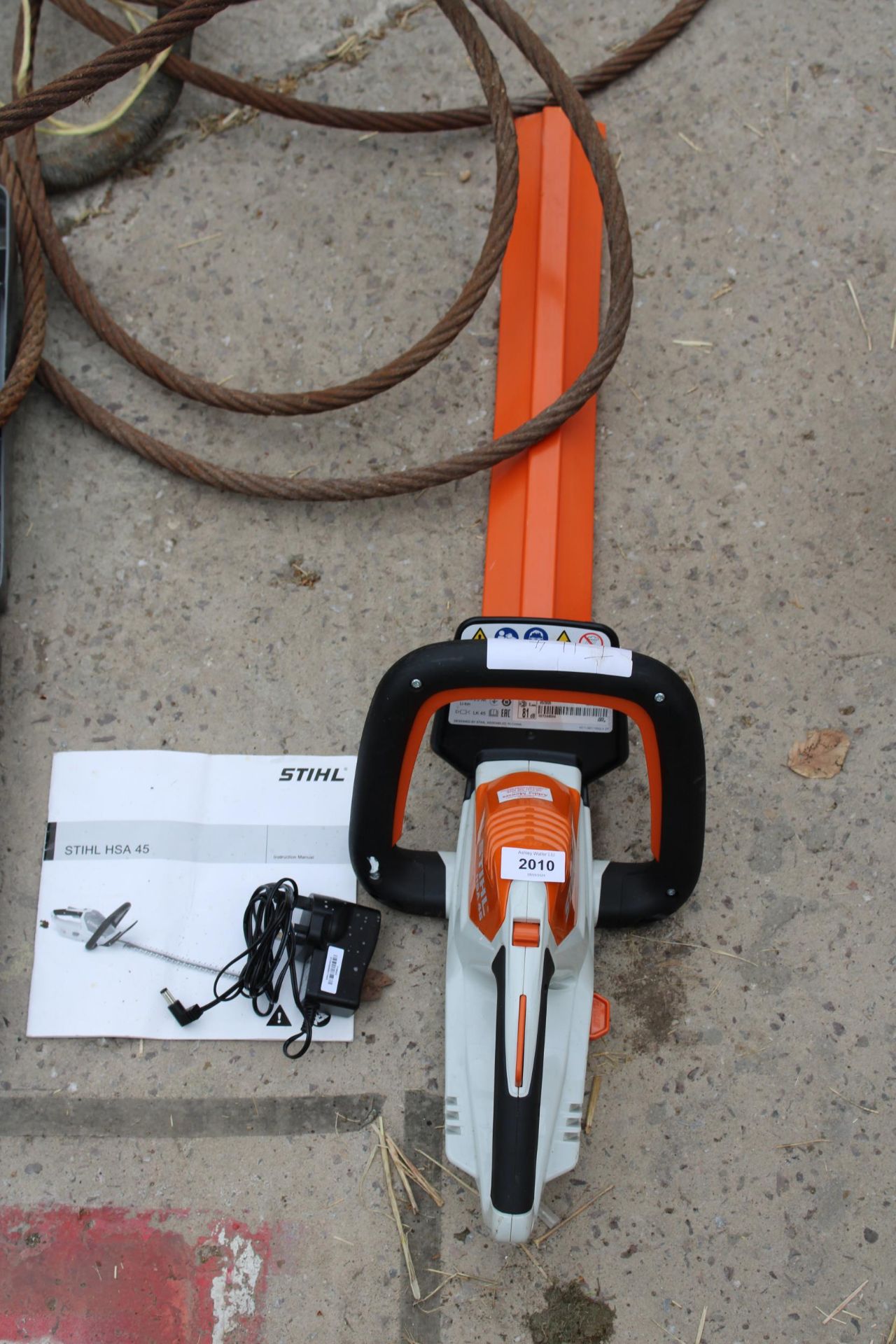 A STIHL HSA 45 BATTERY HEDGE TRIMMER WITH CHARGER AND MANUAL