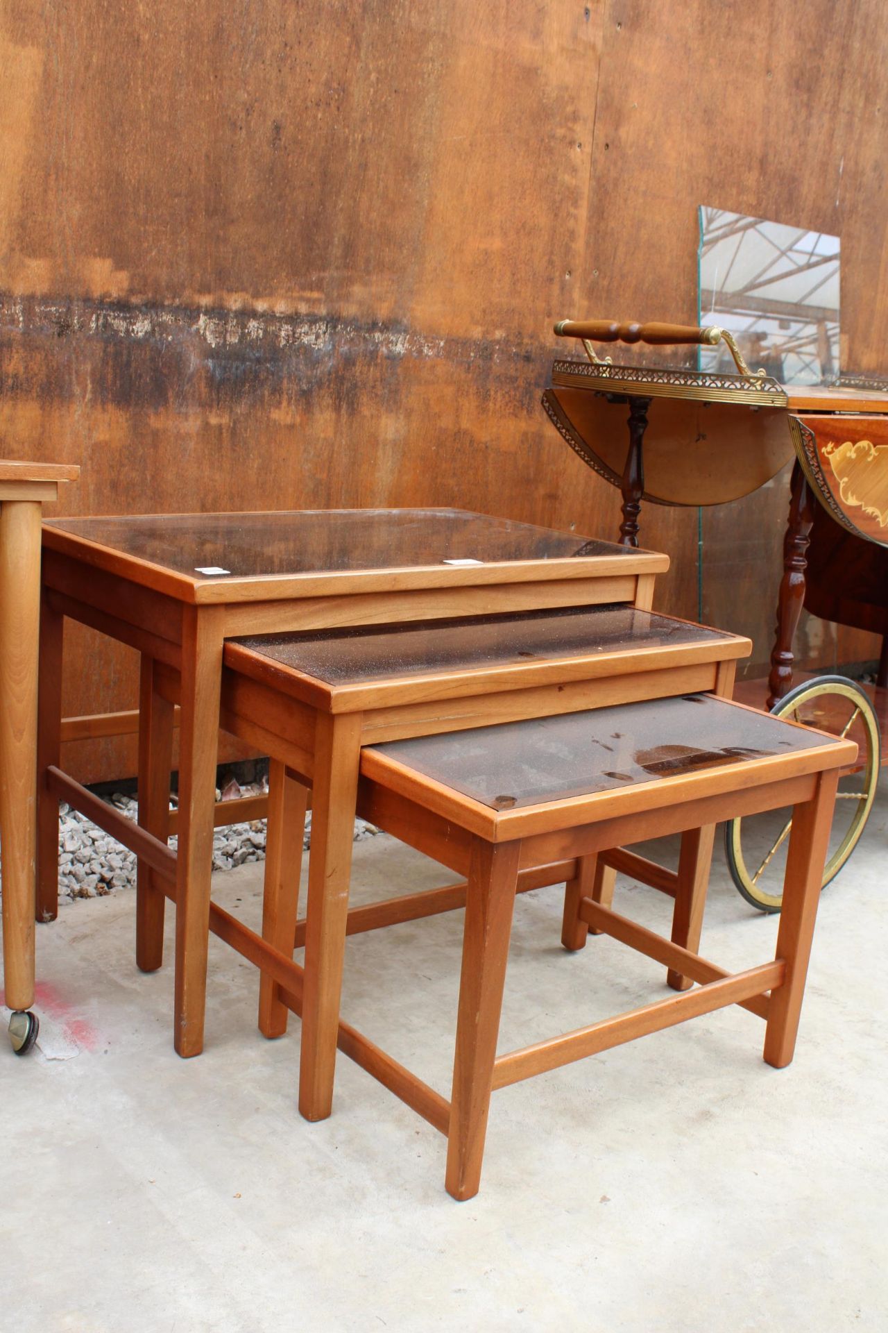 A RETRO TEAK NEST OF THREE TABLES WITH INSET GLASS TOPS - Image 2 of 3