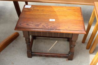 AN OAK JACOBEAN STYLE STOOL ON TURNED LEGS