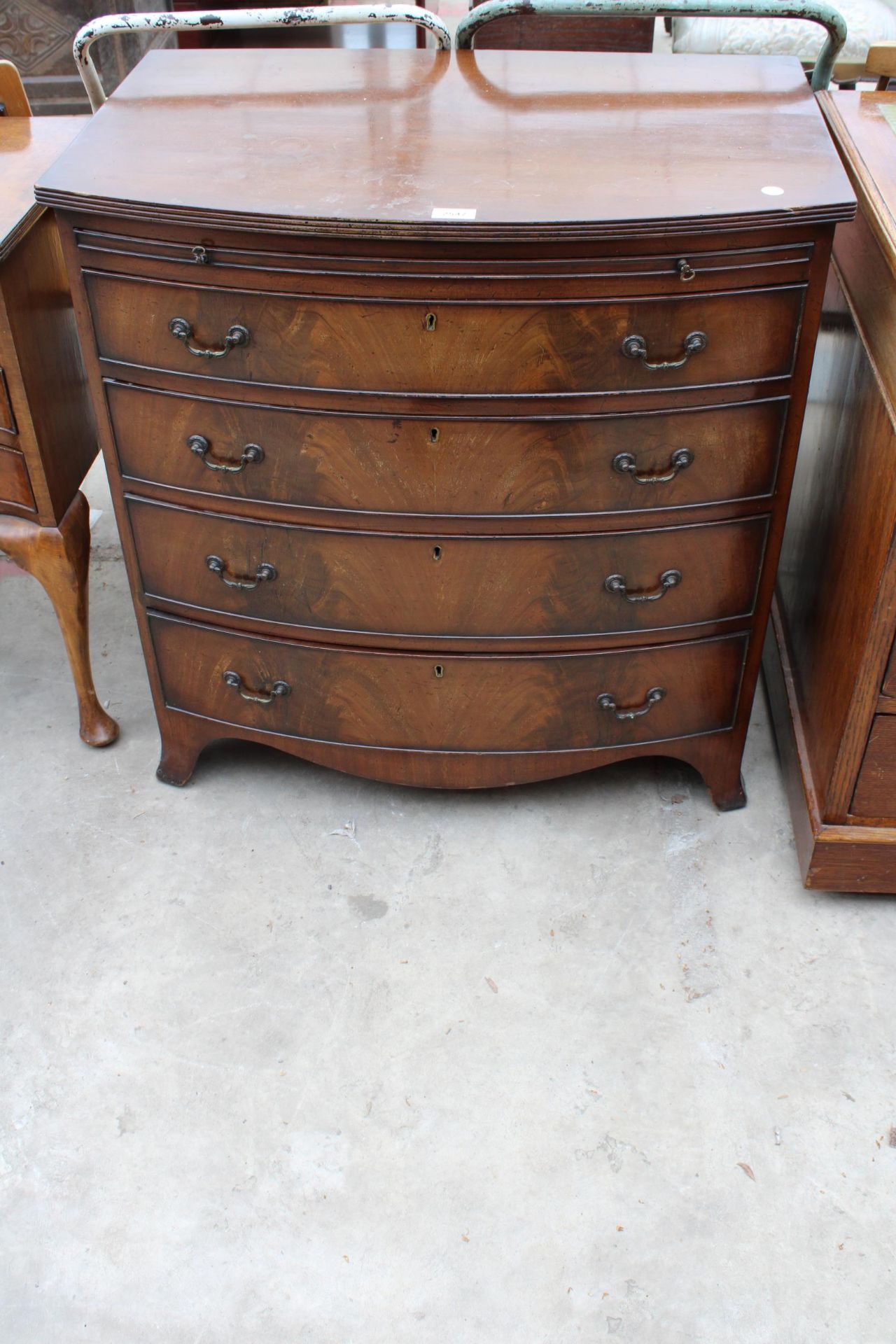 A 19TH CENTURY STYLE BOW FRONTED CHEST OF FOUR GRADUATED DRAWERS WITH SLIDE, 30" WIDE