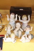 THREE LARGE AND FOUR SMALL ANTIQUE PORCELAIN, BISQUE DOLLS