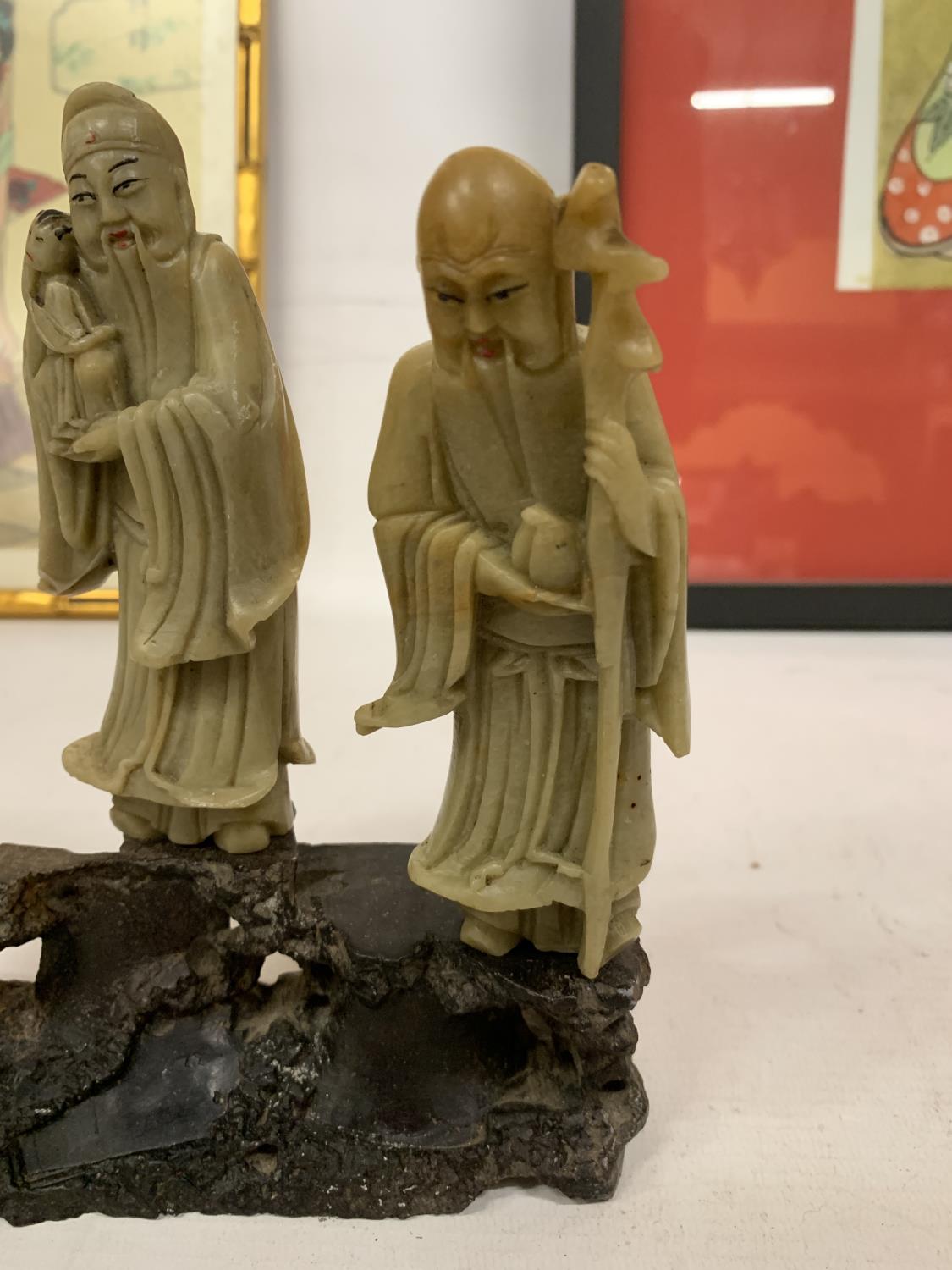 A FINE CHINESE CARVED SOAPSTONE FIGURE GROUP OF THREE IMMORTALS MOUNTED ON A CARVED STAND - Image 2 of 4
