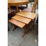 A RETRO TEAK NEST OF THREE TABLES STAMPED 'MADE IN DENMARK'