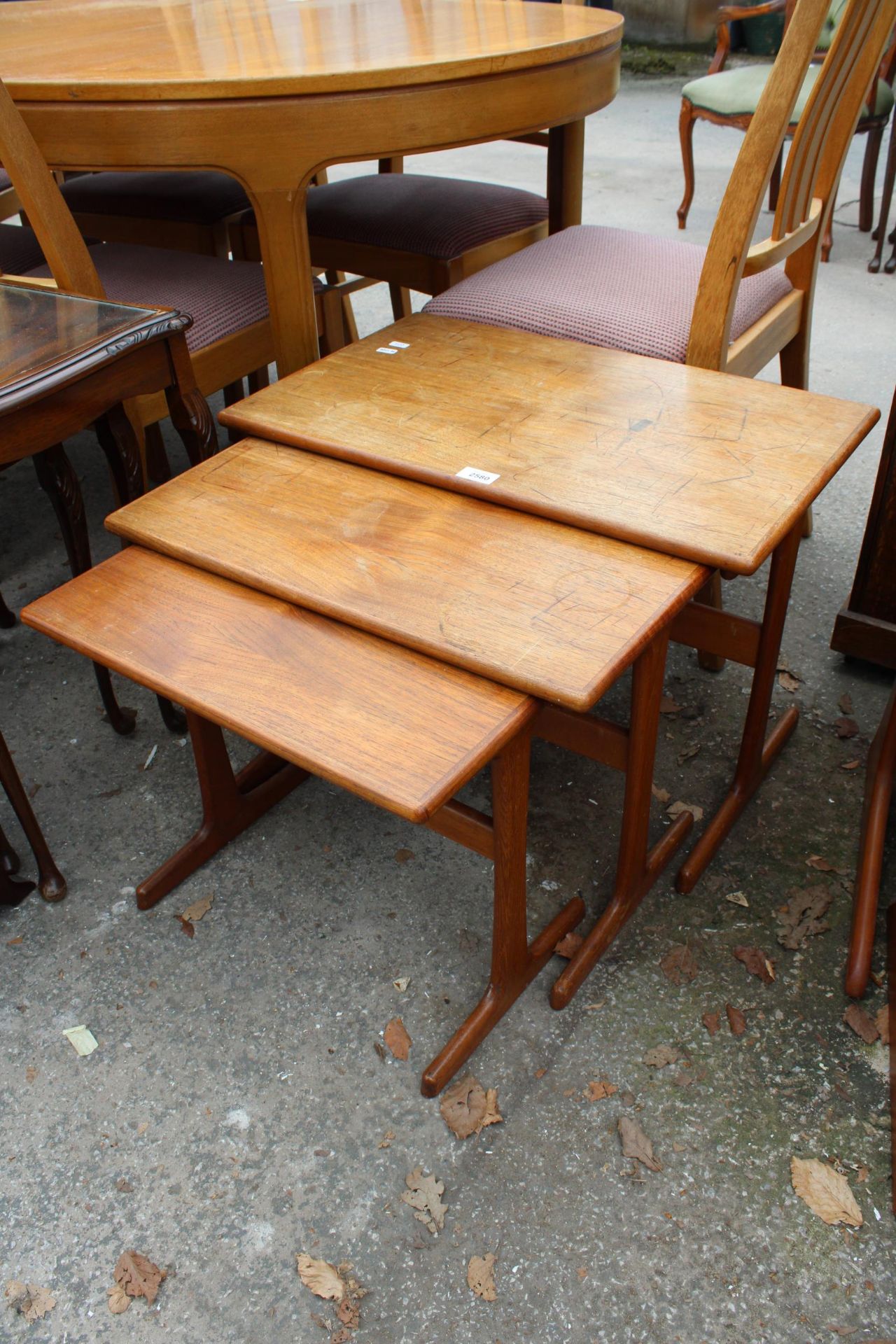 A RETRO TEAK NEST OF THREE TABLES STAMPED 'MADE IN DENMARK'