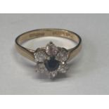 A 9 CARAT GOLD RING WITH A SAPPHIRE SURROUNDED BY CUBIC ZIRCONIAS SIZE N