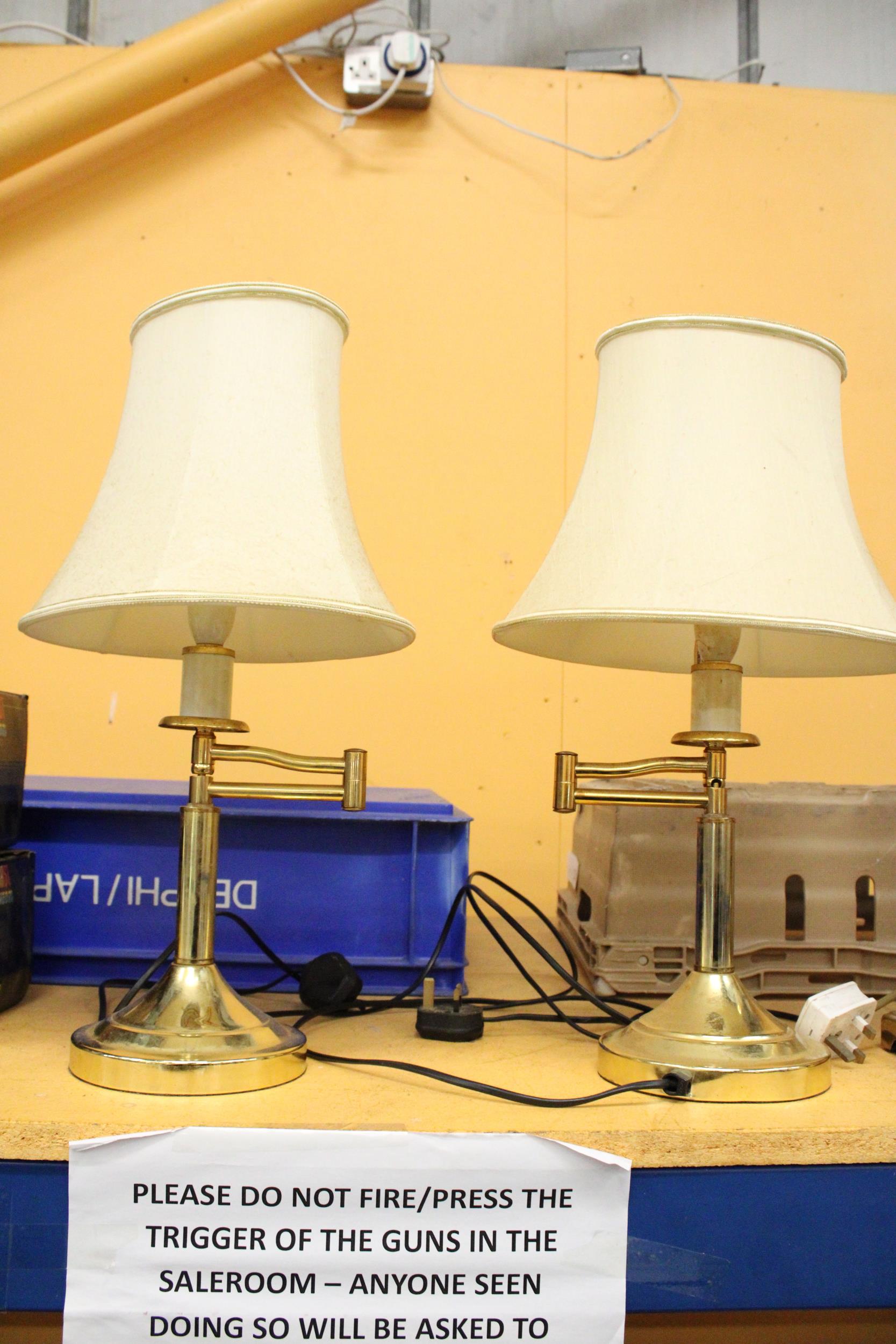 A PAIR OF VINTAGE SWING ARM BRASS LAMPS WITH SHADES