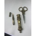 A PAIR OF DECORATIVE BRASS DRESS MAKING SCISSORS AND A NEEDLE CASE