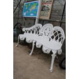 A DECORATIVE WHITE PAINTED CAST ALLOY THREE SEATER BENCH