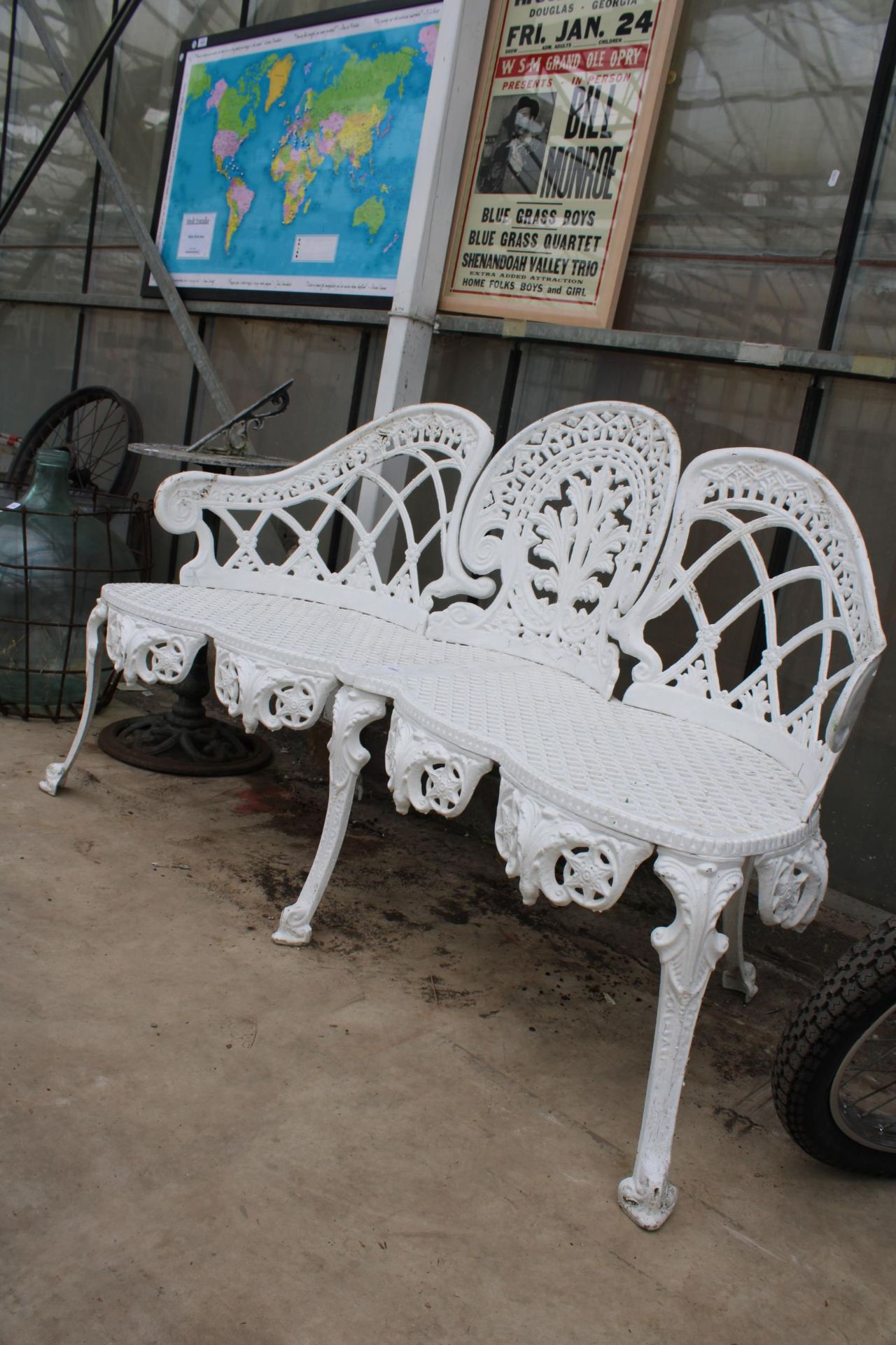 A DECORATIVE WHITE PAINTED CAST ALLOY THREE SEATER BENCH