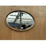 AN OVAL BEVEL EDGE WALL MIRROR, 25" X 17"