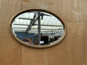 AN OVAL BEVEL EDGE WALL MIRROR, 25" X 17"