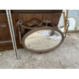 AN ORNATE OVAL MIRROR (FRAME A/F)