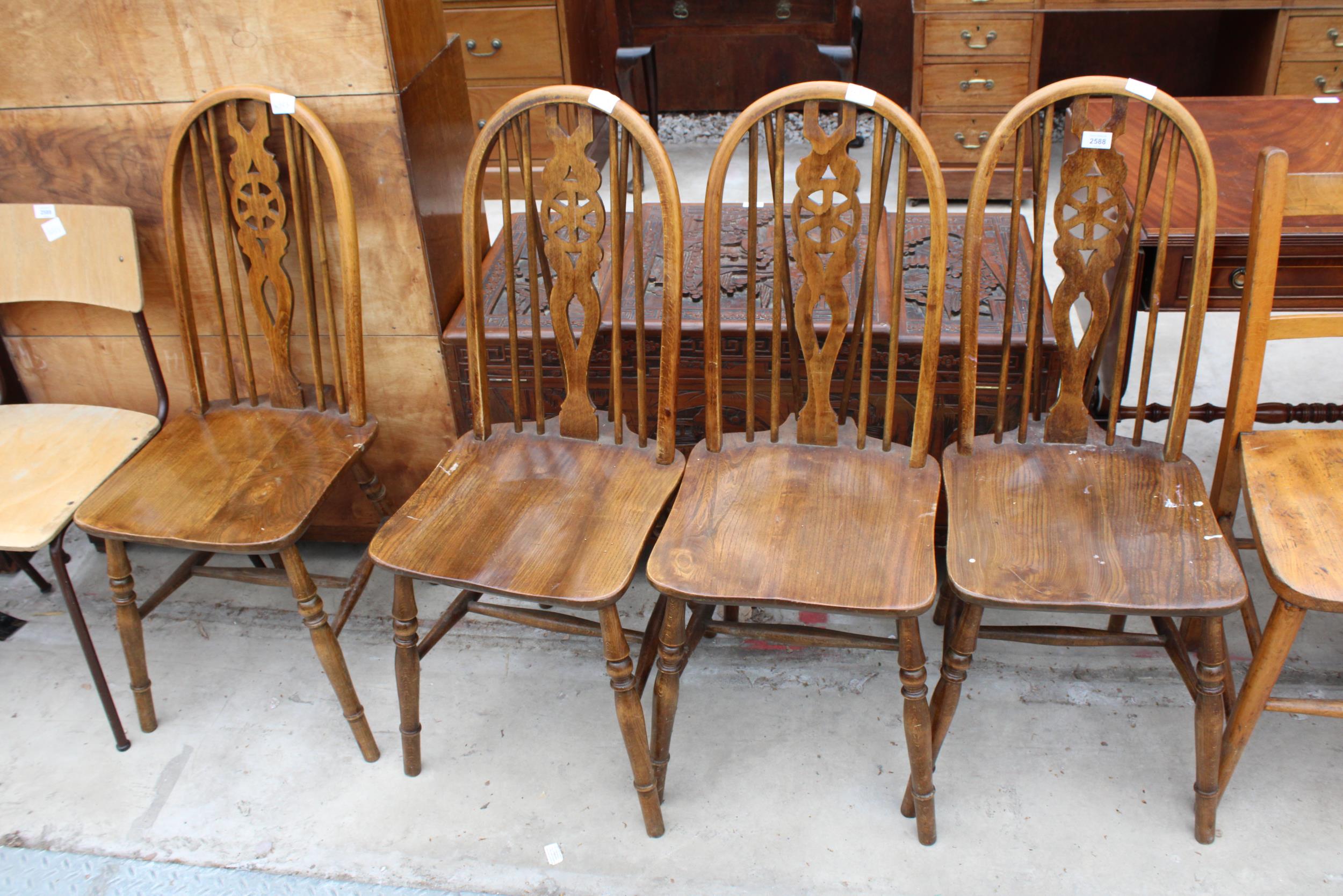 A SET OF FOUR MODERN WHEEL-BACK DINING CHAIRS