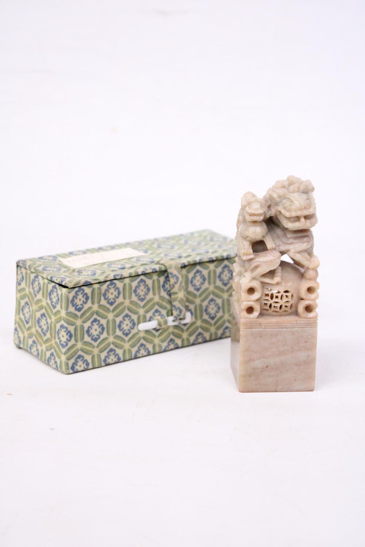 A CHINESE HAND CARVED SOAPSTONE FOO DOG SEAL
