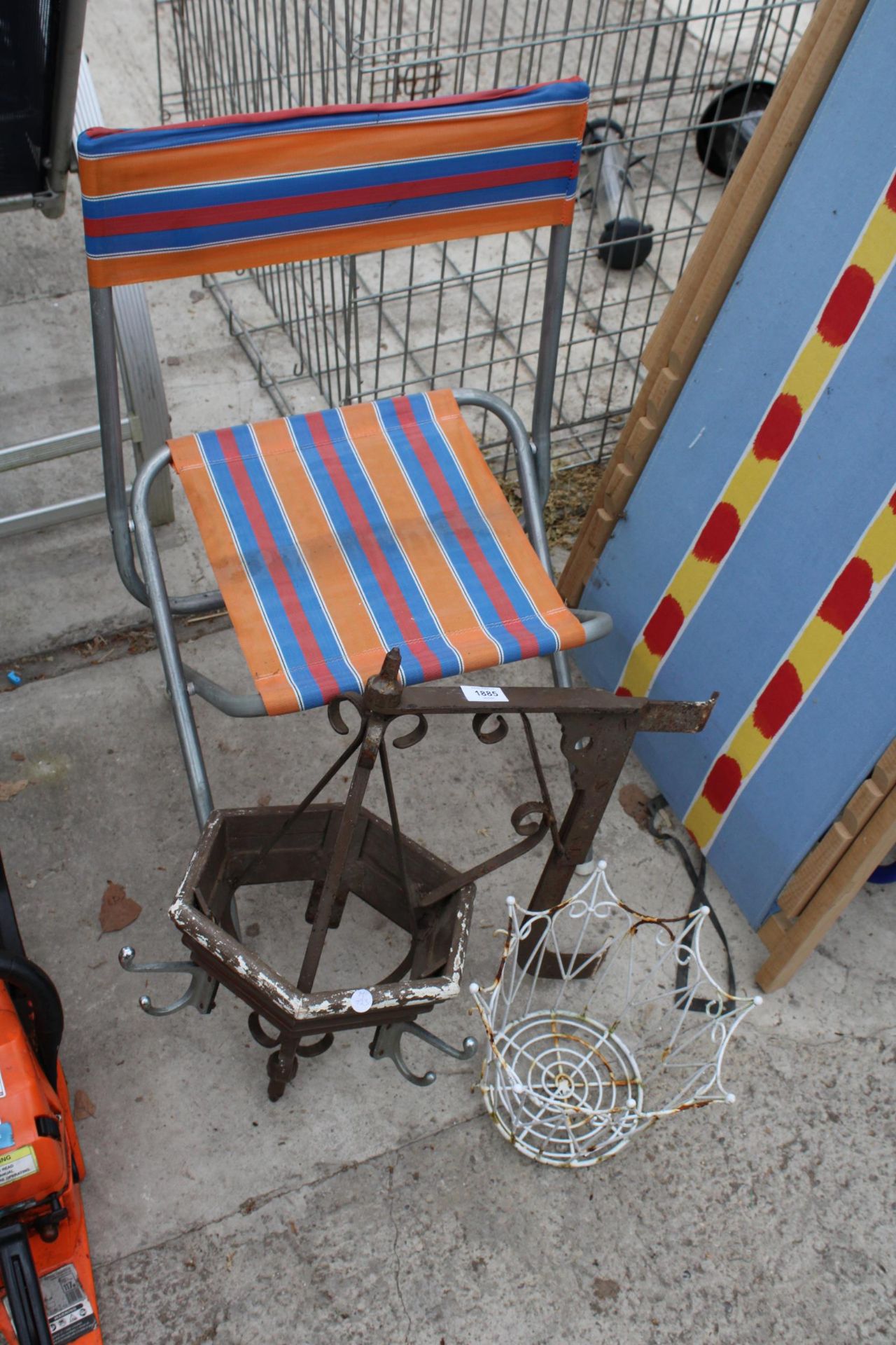 A FOLDING CHAIR, A HANGING BRACKET AND A WIRE PLANTER
