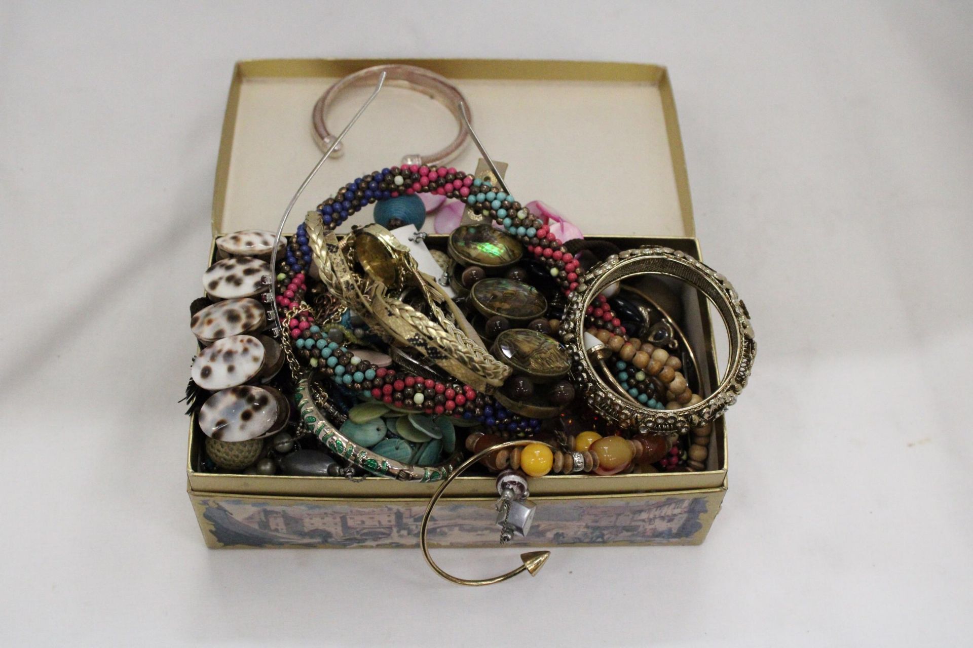 A QUANTITY OF COSTUME JEWELLERY TO INCLUDE NECKLACES, EARRINGS, BANGLES, ETC, IN A DOMED BOX