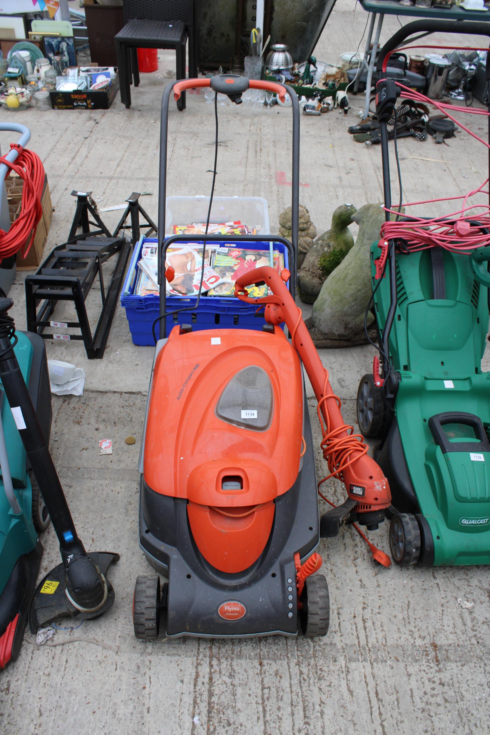 A ROLLER COMPACT 400 FLYMO LAWN MOWER AND AN ELECTRIC BLACK AND DECKER GRASS STRIMMER