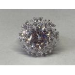 A WHITE METAL RING WITH 5 CARAT OF MOISSANITE IN A CLUSTER DESIGN SIZE O