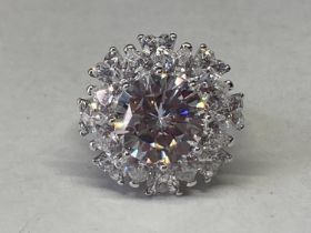 A WHITE METAL RING WITH 5 CARAT OF MOISSANITE IN A CLUSTER DESIGN SIZE O