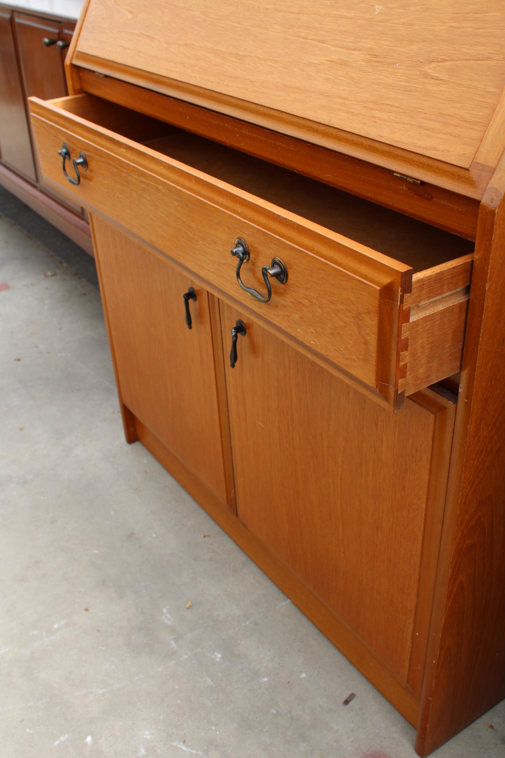 A RETRO TEAK BUREAU WITH CUPBOARDS AND SINGLE DRAWER TO BASE, 33" WIDE - Image 3 of 3