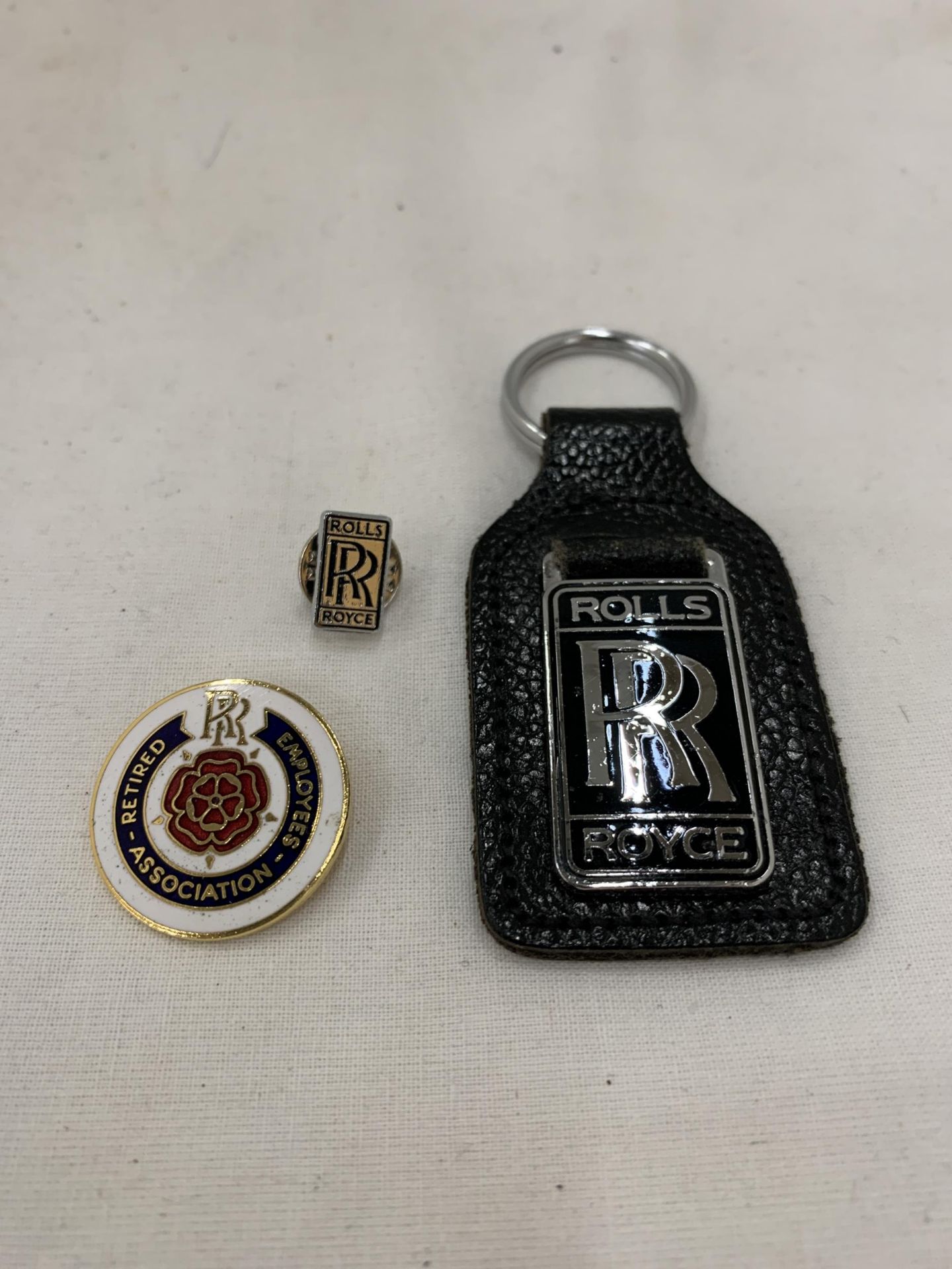TWO ROLLS ROYCE BADGES AND A KEY FOB