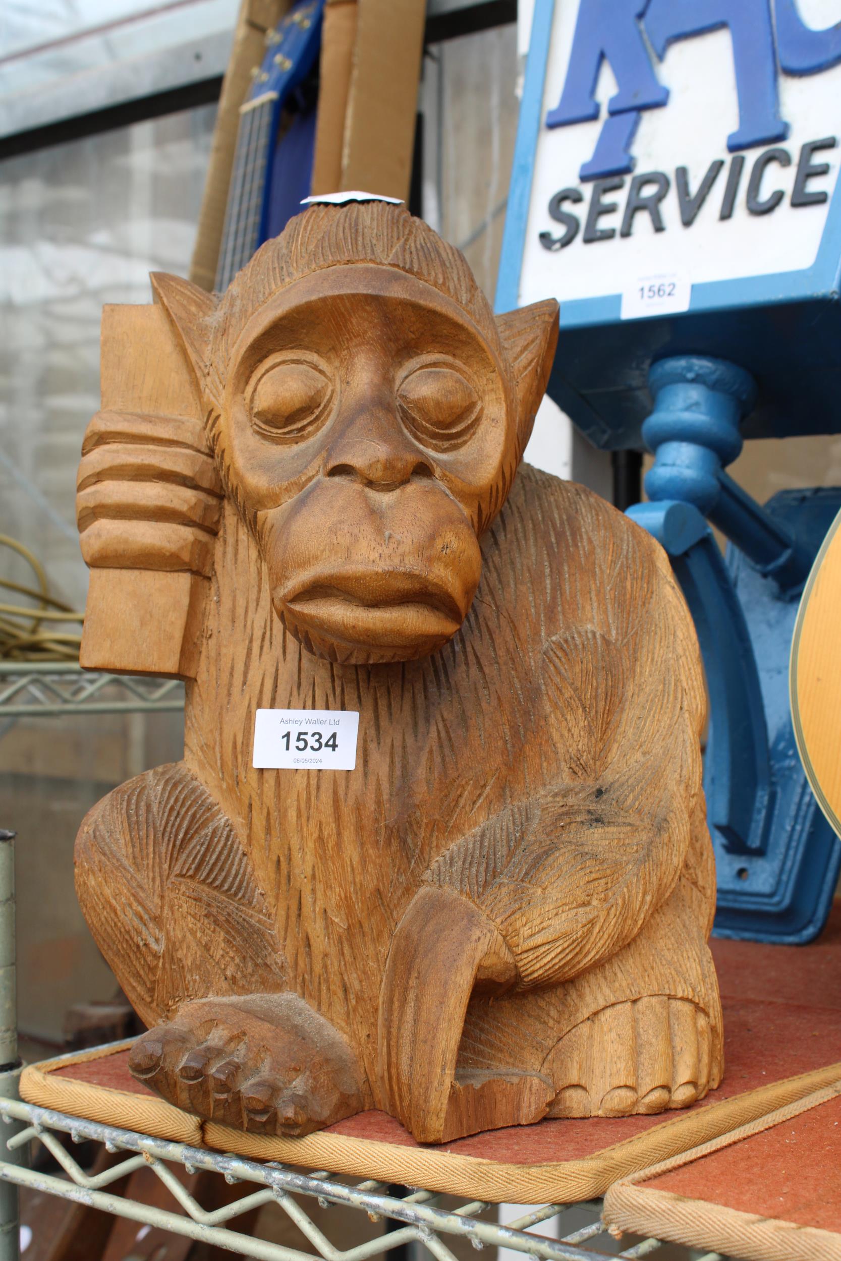 A WOODEN CARVED MONKEY FIGURE