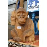 A WOODEN CARVED MONKEY FIGURE