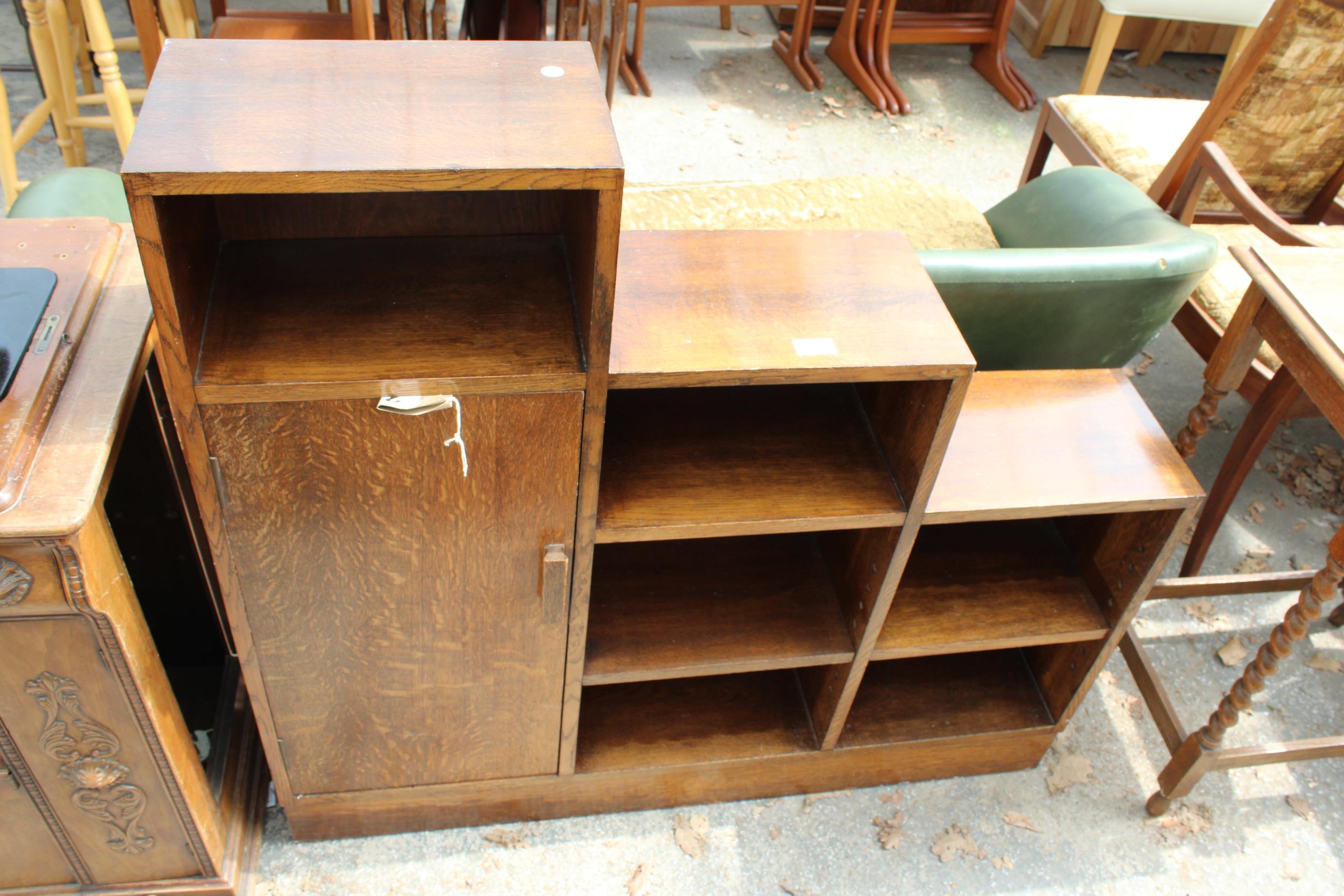 A MID 20TH CENTURY STEPPED OAK BOOKCASE WITH SINGLE CUPBOARD, 42" WIDE, BEARING JONES MOSS & CO,