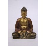 A SMALL RESIN GOLD COLOURED BUDDHA STATUE (16 CM)