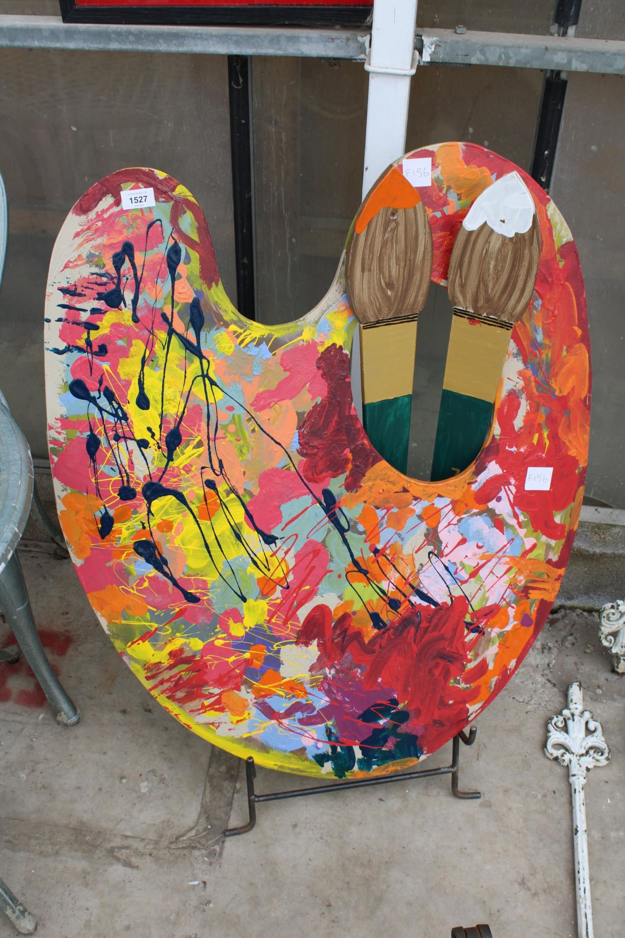 A LARGE WOODEN ARTIST PALLET AND TWO PAINT BRUSHES