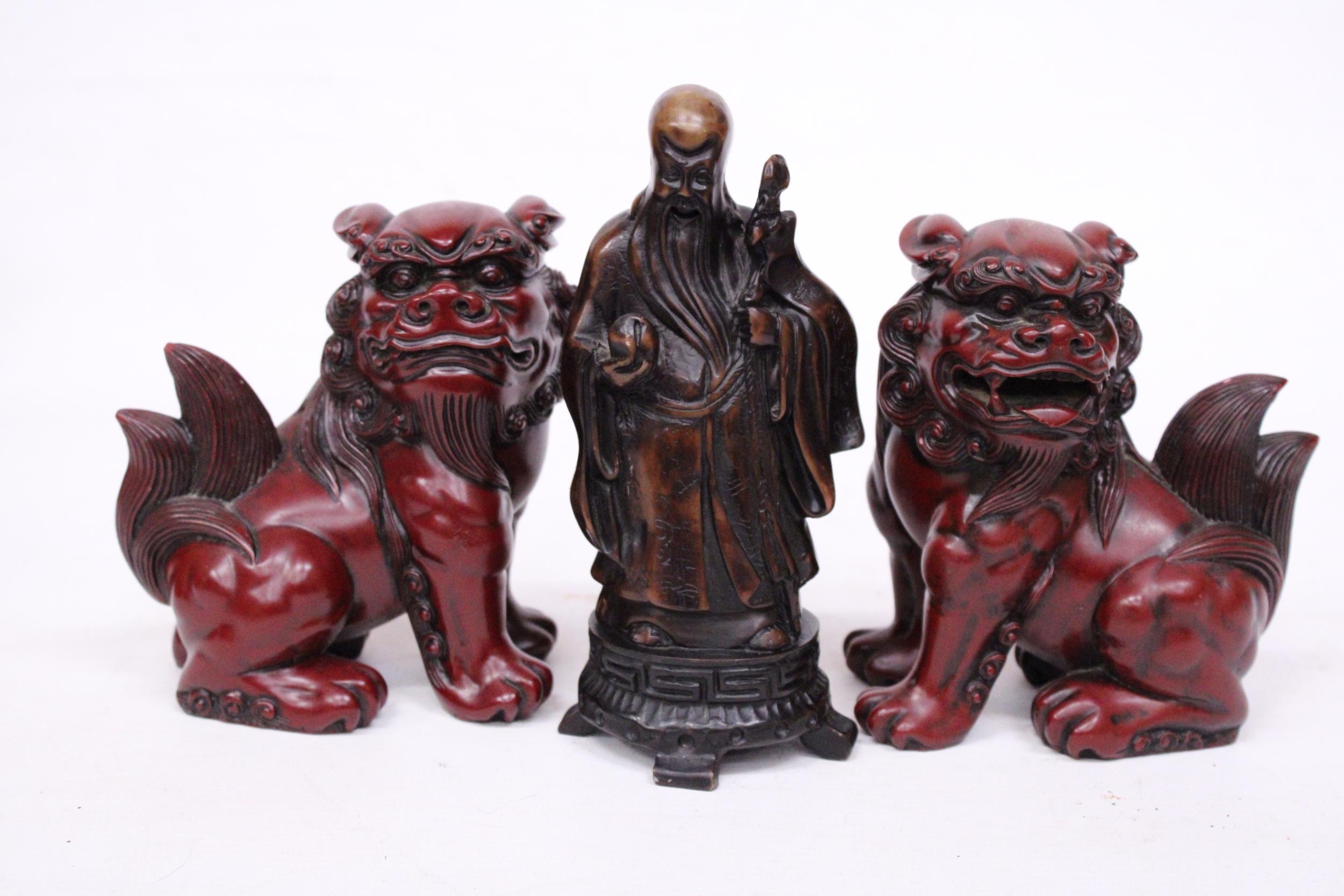 A PAIR OF CHINESE FOO DOGS AND A CHINESE WISEMAN