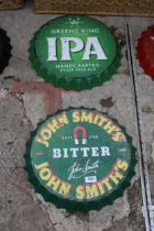 TWO BOTTLE CAP STYLE SIGNS TO INCLUDE JOHN SMITHS ETC