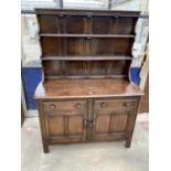 AN ELM ERCOL BLUE LABEL DRESSER ENCLOSING TWO DRAWERS AND TWO CUPBOARDS WITH PLATE RACK, 48" WIDE