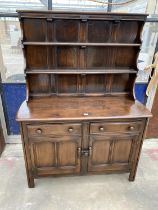 AN ELM ERCOL BLUE LABEL DRESSER ENCLOSING TWO DRAWERS AND TWO CUPBOARDS WITH PLATE RACK, 48" WIDE