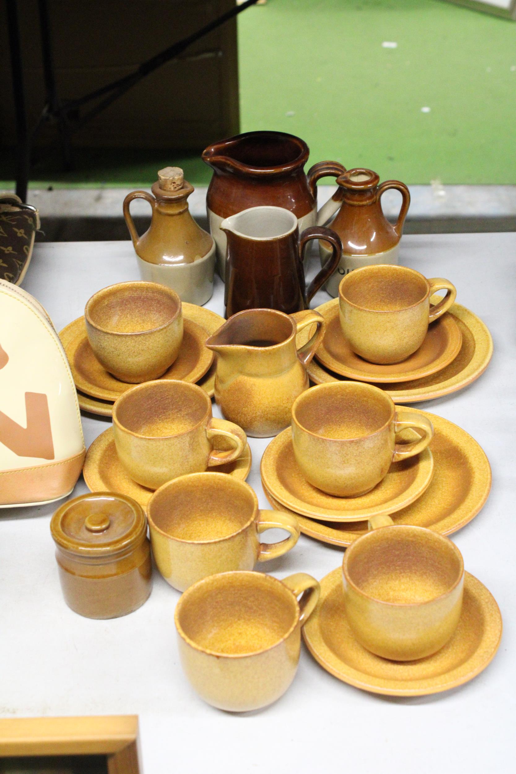 A STONEWARE COFFEE SET TO INCLUDE A CREAM JUG, SUGAR BOWL, CUPS, SAUCERS AND SIDE PLATES, PLUS JUGS,