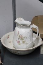 A LARGE FLORAL JUG AND BOWL WITH INDISTINCT STAMP TO BASE